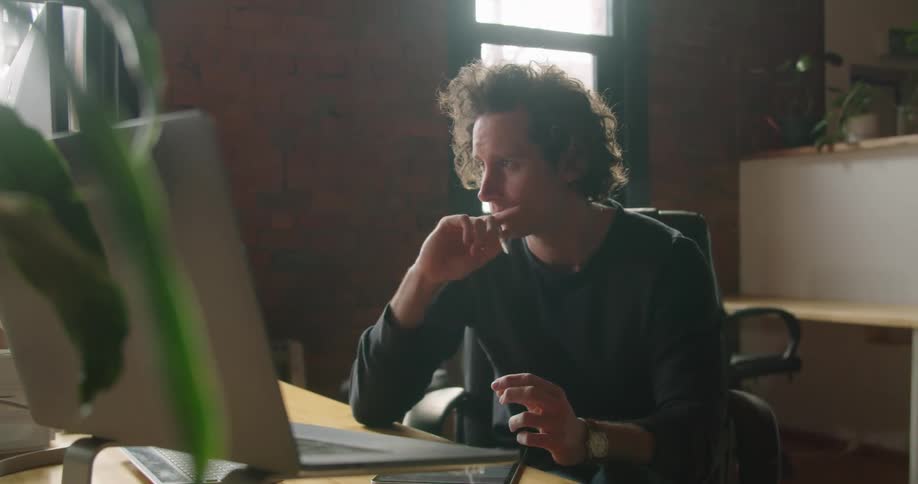Man sitting at the table talks to someone in the office building