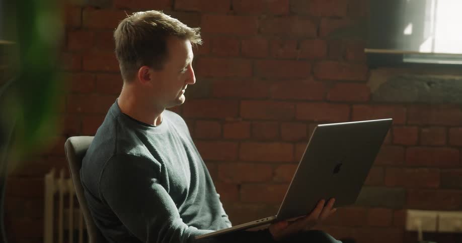 A man talks to someone on his laptop