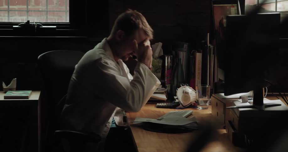 An exasperated doctor talks on the phone