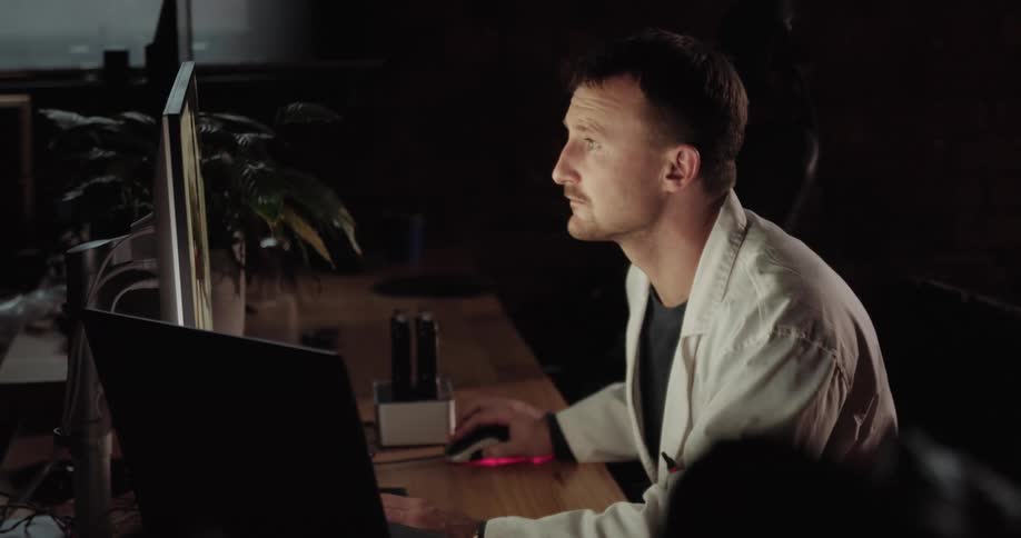 A person is using a computer and sitting at a desk