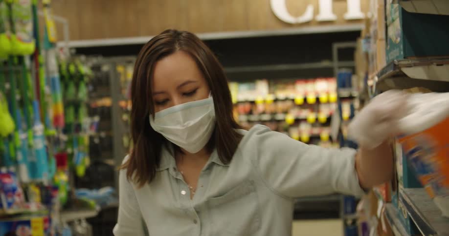 Woman wearing mask and gloves grocery shopping