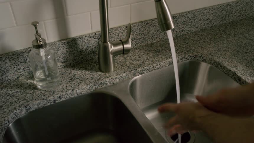 A person is washing their hands in a sink