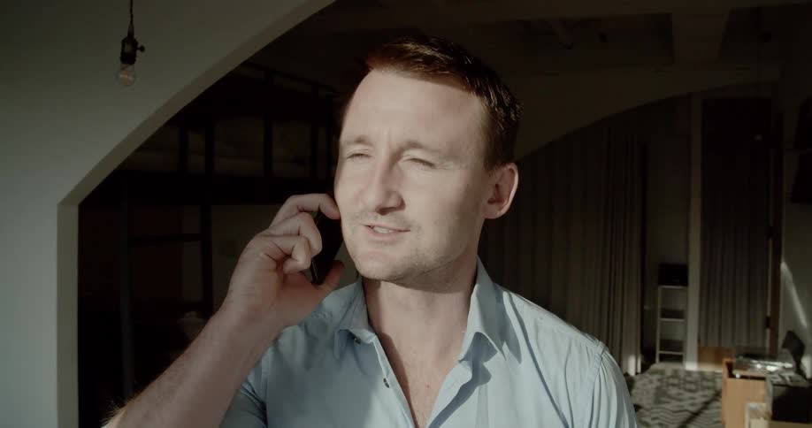 A man standing talking on a cell phone