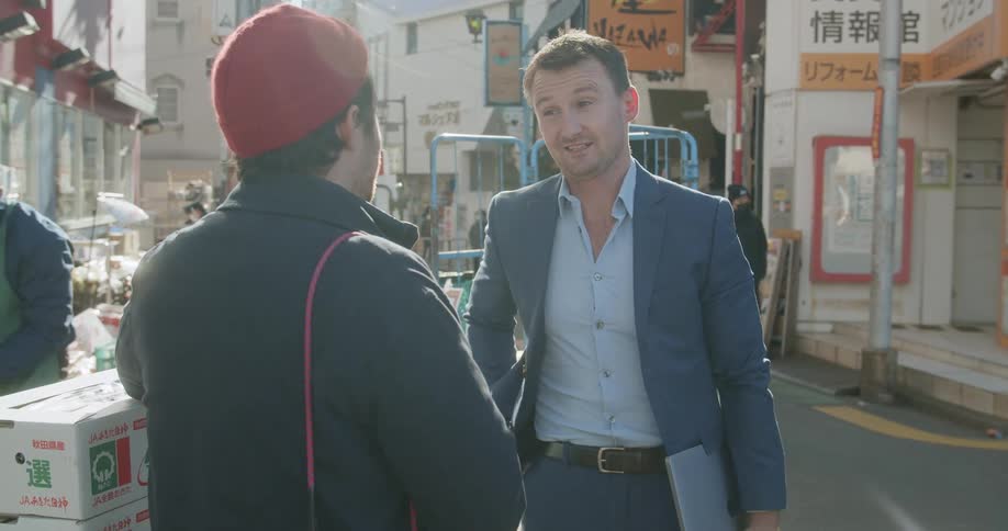 Two men standing and talking on the streets