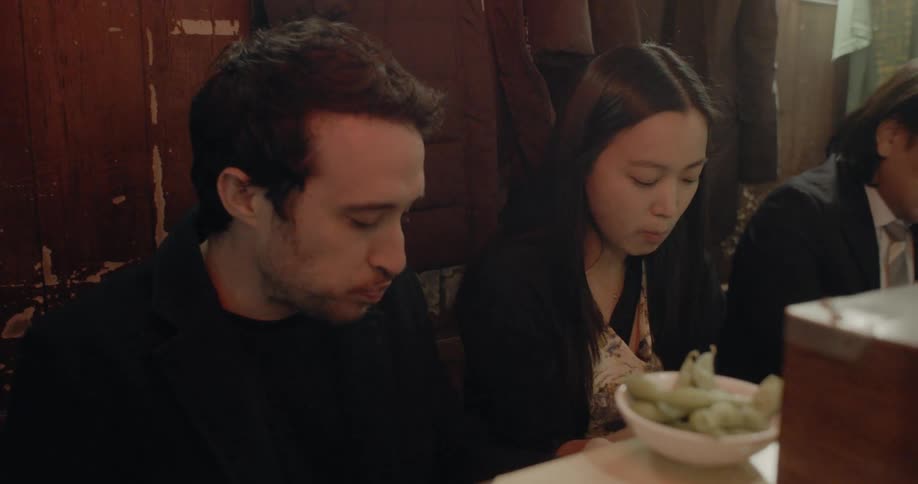 Couple eating food from a street vendor in japan
