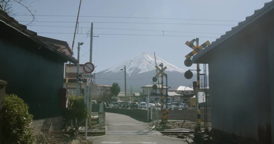 Train tracks in a small town in front of a mountain