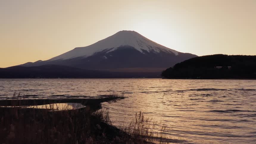 A lake with a mountain in the background