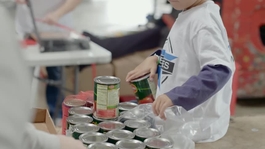 People unpacking bulk groceries on warehouse