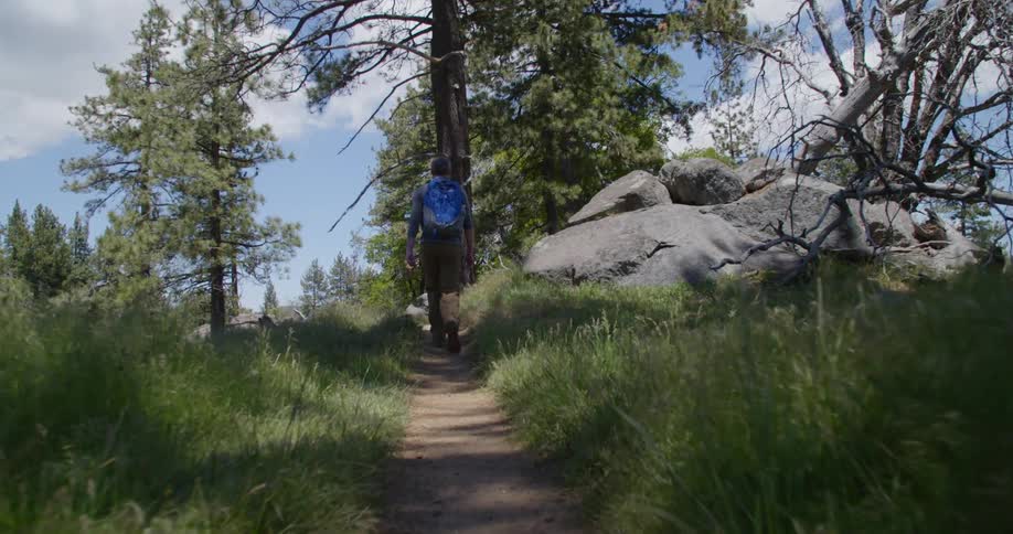 A person walking down a trail with a backpack on