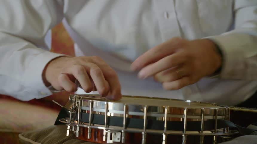 A man strings a banjo