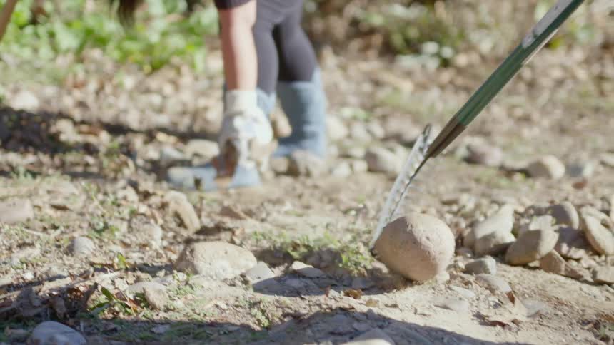 A person raking a rock