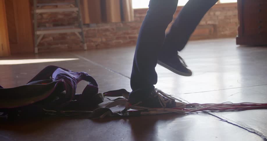 A person taken off a parachute harness and walking away