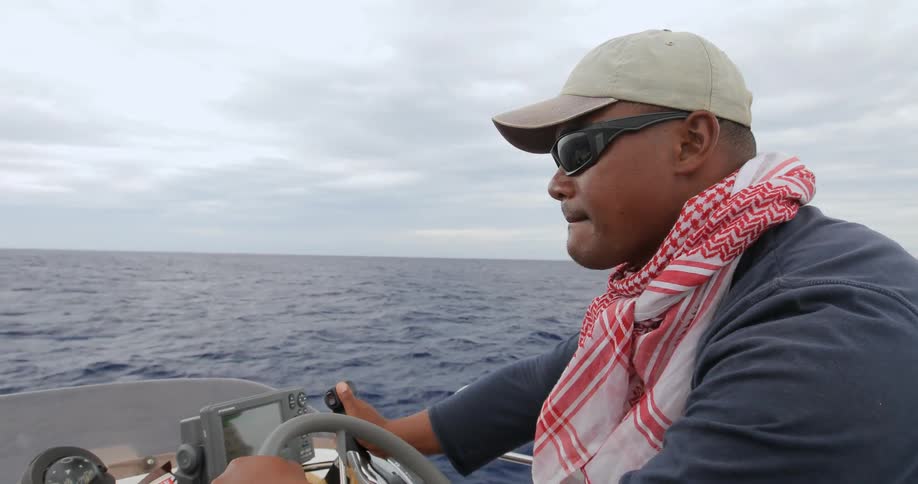 A man steers a boat