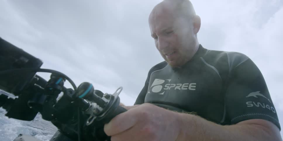 A diver looks at his equipment