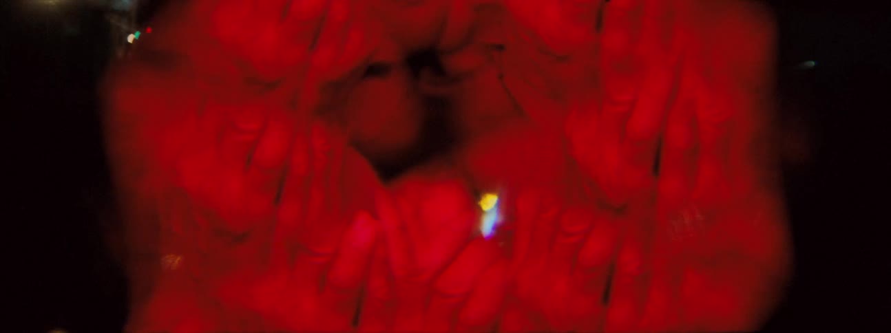 Multiple images of an elderly person rubbing their face with their hands in a red glow