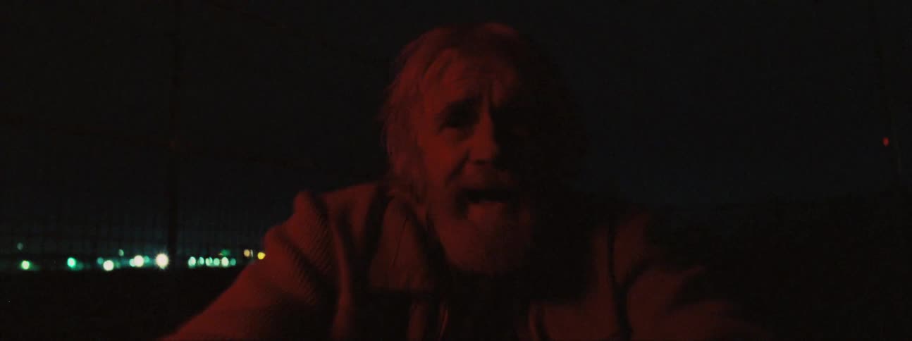 A man acts crazy by a flashing red light