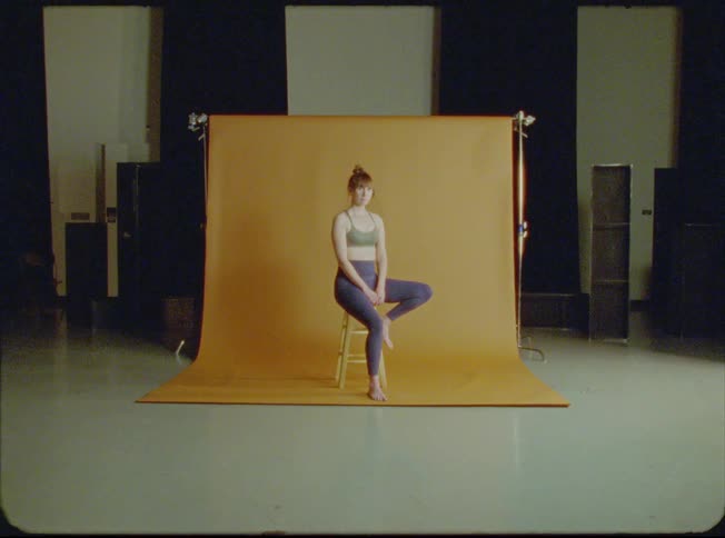 Model wearing exercise clothes poses in photography studio