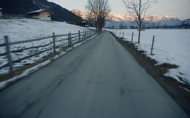 A road goes through farm lands