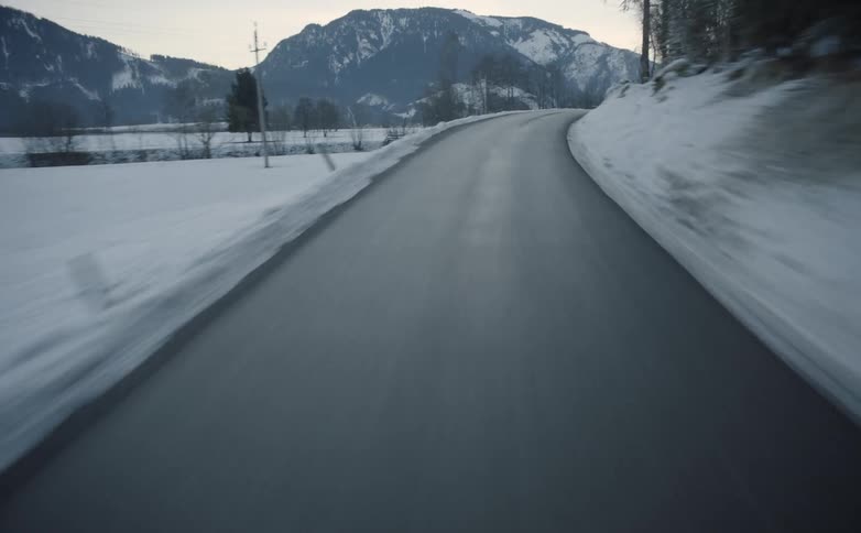 A narrow road in a snowy mountainous area