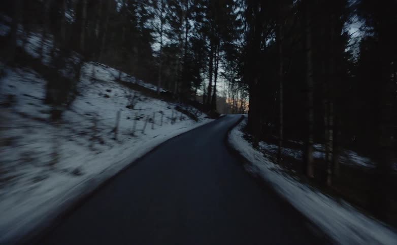 A winding road on a snowy slope in the countryside
