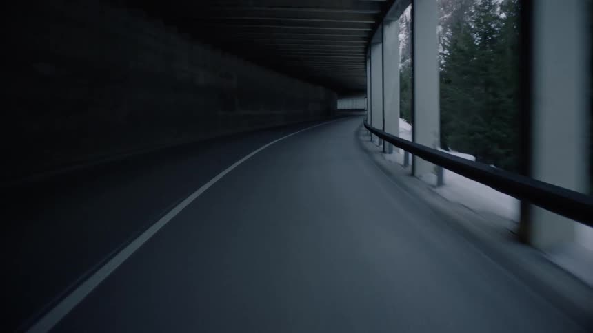 A covered road along side the mountains