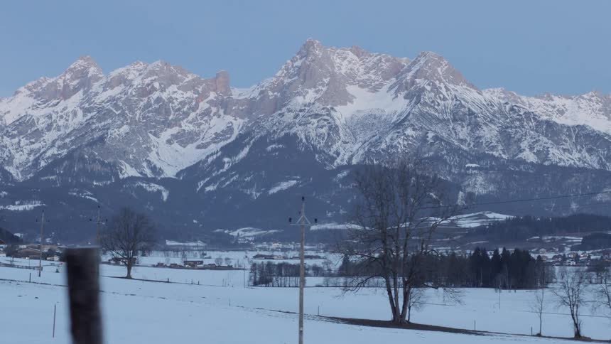 Sun highlights top of mountain bordering town