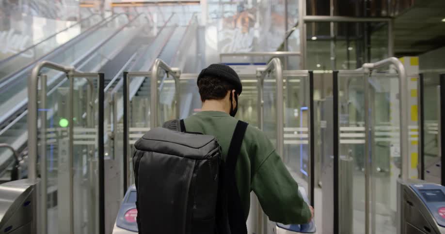 A man walks through the turnstile