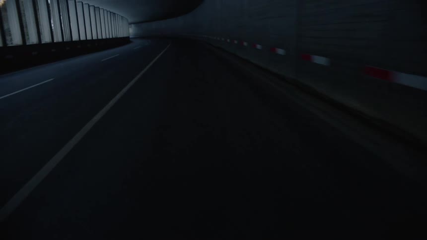 A covered road along side a mountain