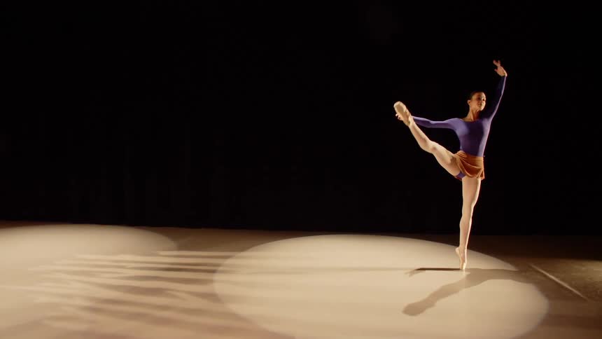 A woman dances on a stage