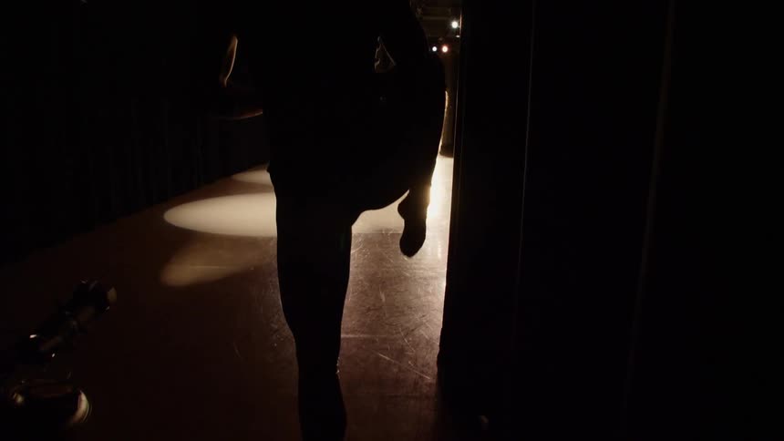 A person stretches in silhouette