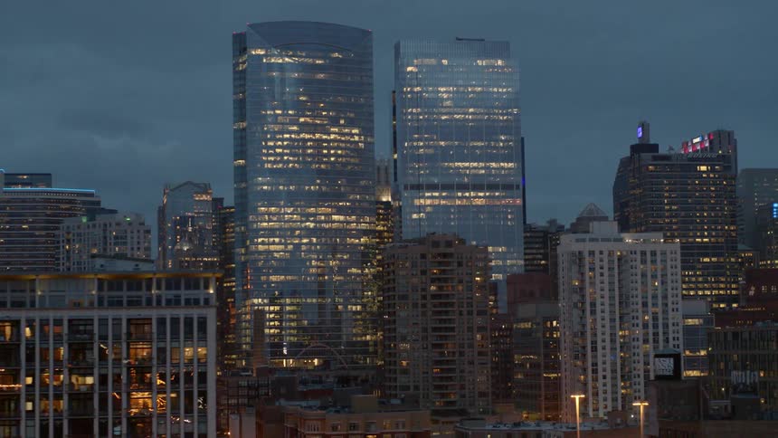 Traffic travels through Chicago and lights reflect off the glass at night