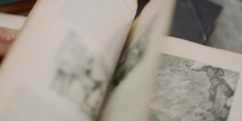Person turns the pages of a book
