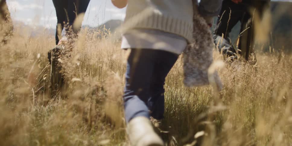 A family runs through a field