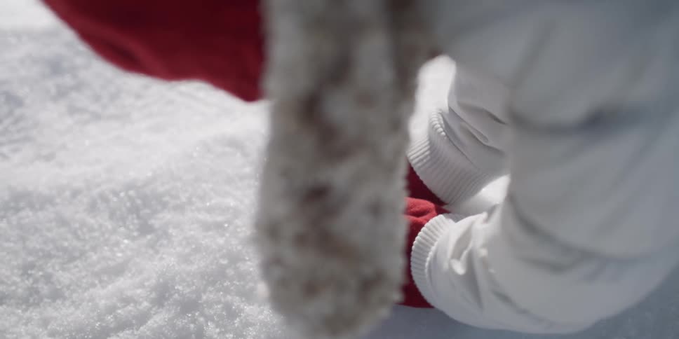 A child scoops up snow