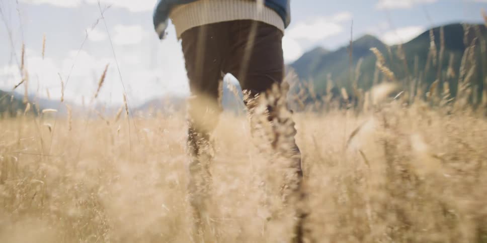 A boy runs through an open field