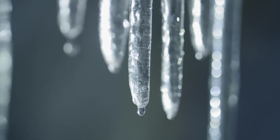 Icicles melt and the water droplets drop
