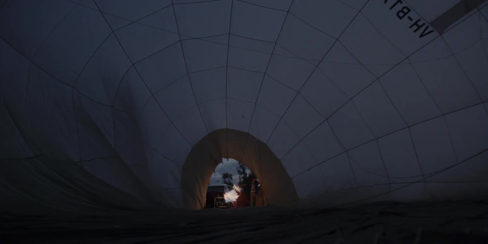 Inside a hot air balloon with flames at the entrance