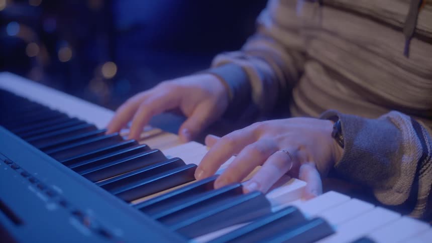 A pianist plays a keyboard