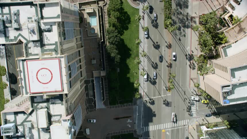 Birds eye view of cars driving down a city street