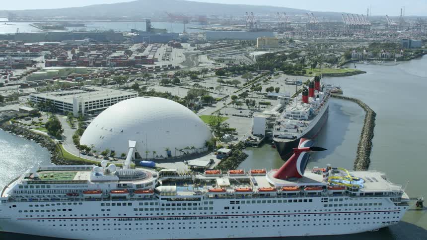 A cruise ships sits by the dock and ocean