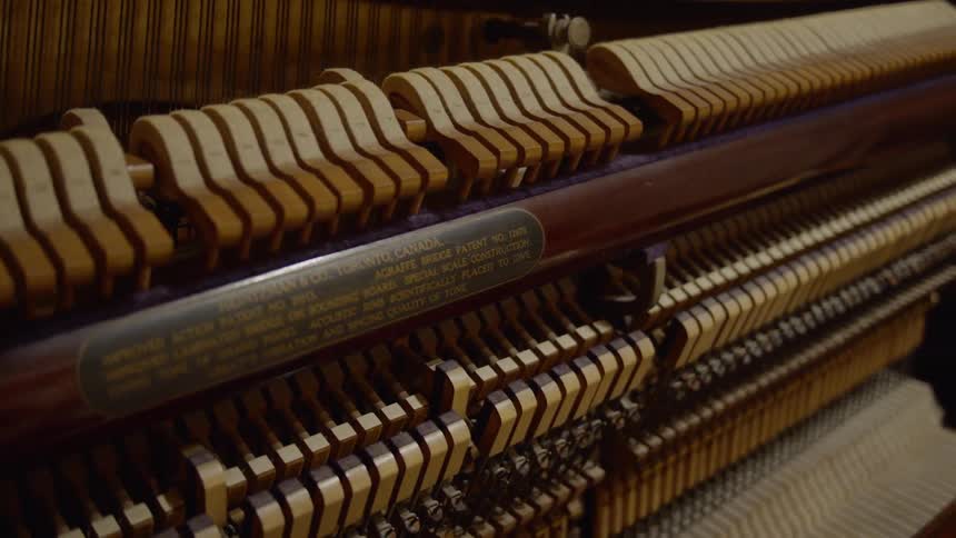 The internal workings of a piano as its being played