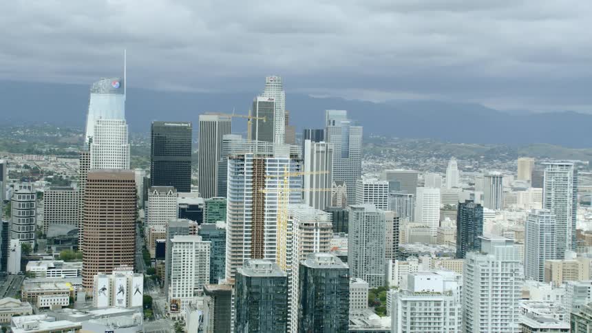 Office buildings and skyscrapers sit under the cloudy sky