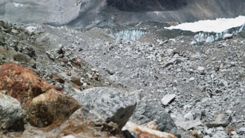 Rocks gravel and snow at the base of a canyon