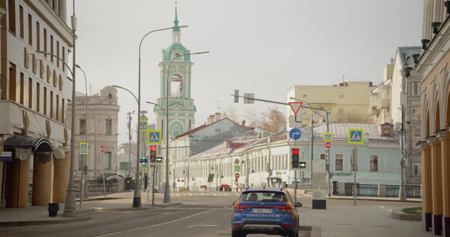 A lone car is parked on the city street