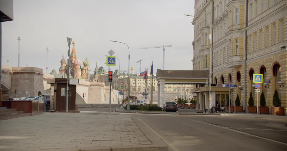 Empty street leads past buildings toward kremlin on the horizon