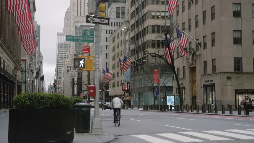 A man cycles down a city street