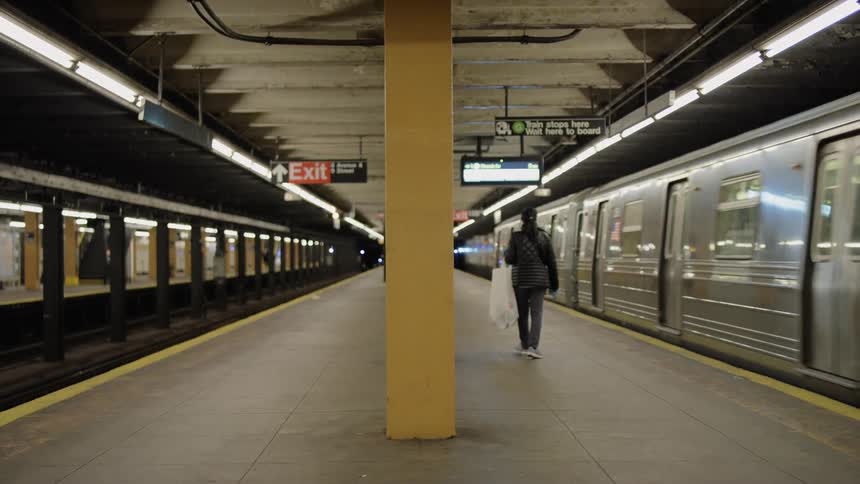 A woman walks towards a train