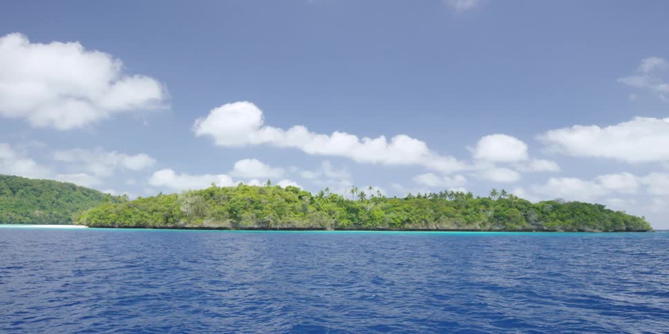 Tropical island surrounded by blue ocean water