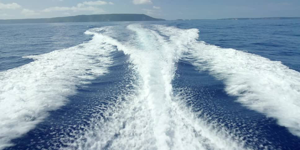 The wake behind a fat moving boat in the ocean