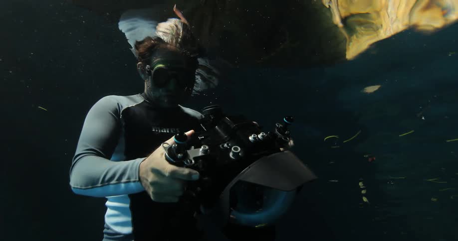 A man takes pictures underwater